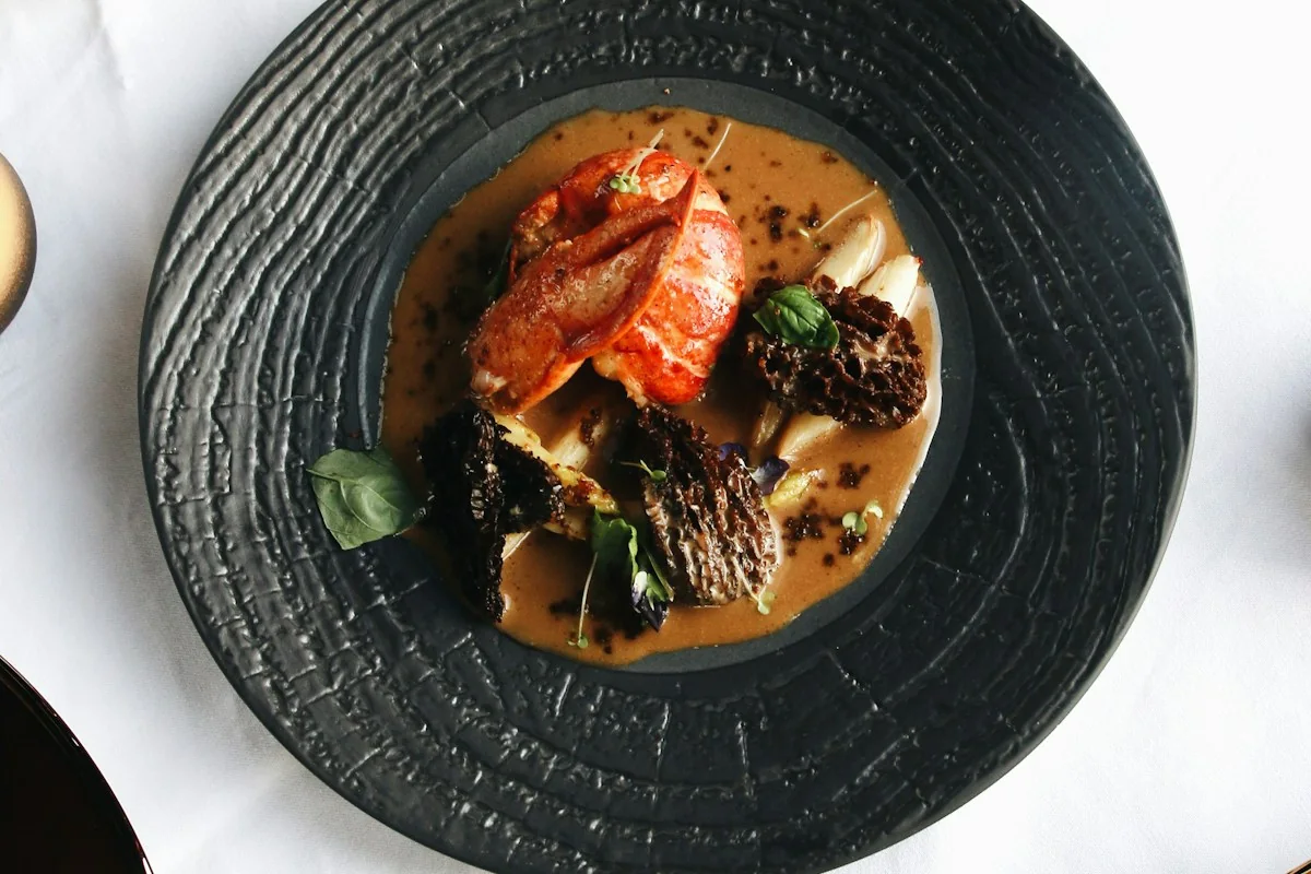 A carefully plated dish on a dark ceramic plate